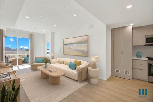 A modern living room with a large painting on the wall and a coffee table in the center.