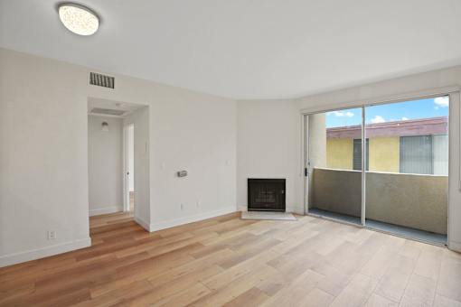 Dining and Living Room Space with Vinyl Flooring, Fireplace, and Balcony