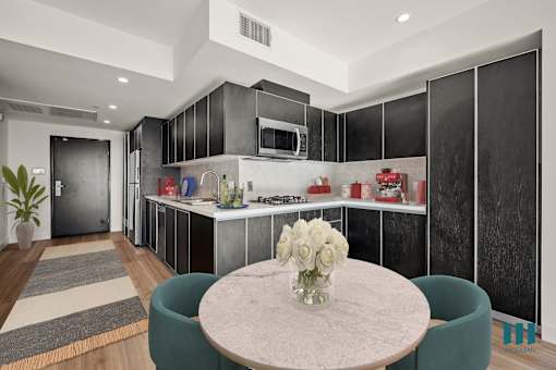Kitchen and Dining Area with Cabinet Storage at Ogden Garden by Wiseman, California, 90036