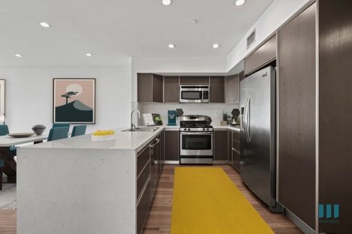 Kitchen with Energy-Efficient Appliances, Ample Cabinet Storage, and Countertop Bar