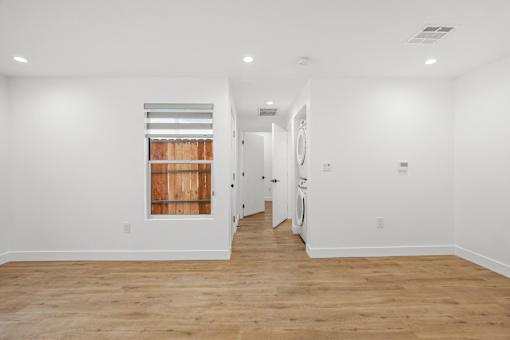 Living Room with Vinyl Flooring, Recessed Lighting, and In-Suite Washer & Dryer