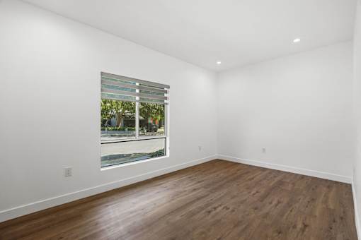 Bedroom with Large-Size Windows, Recessed Lighting, and Vinyl Floors