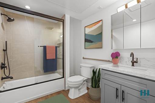 Bathroom with Shower-Bath with a Glass Door and Vanity Cabinet Storage
