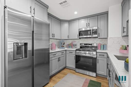 Kitchen with Stainless-Steel Refrigerator, Stove, Microwave Oven, and Dishwasher