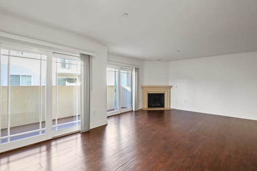 Spacious Living Room with with Vinyl Flooring, Electric Fireplace, and Patio