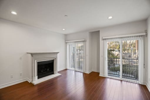 Living Room Area with an Electric Fireplace,  Vinyl Flooring, and Balcony