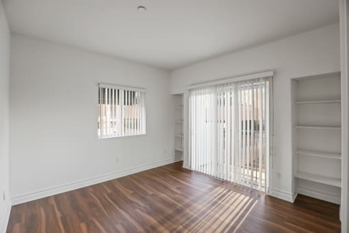 Bedroom with Built-In Shelving and Balcony