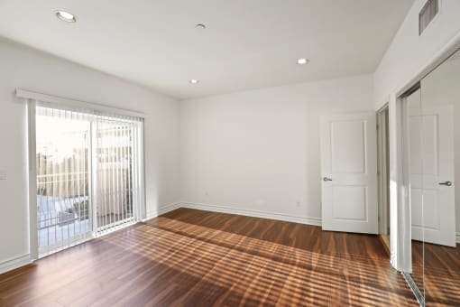 Bedroom with Closet, Balcony, and Vinyl Flooring