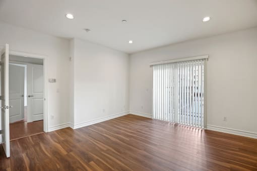 Living Room Space with In-Suite Alarm System, Recess Lighting, and Balcony