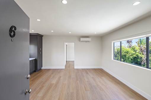 Front Entrance Leading to Living Room with Large-Size Window, Recessed Lighting, and Vinyl Flooring