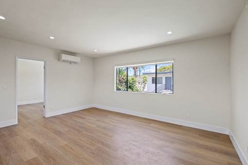 Living Room Space with Large-Size Windows, Recessed Lighting, and Vinyl Flooring
