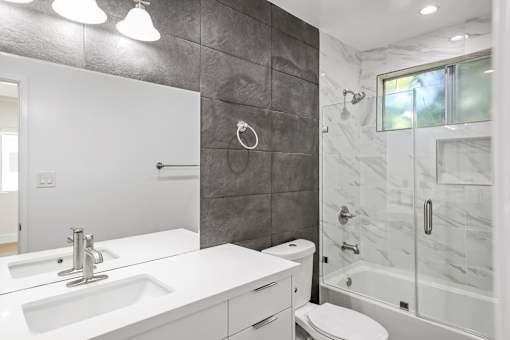 Bathroom with Shower Bath with Glass Door and Vanity Cabinet Storage