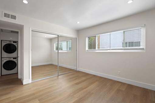 Bedroom with Large Mirrored Closet and Window