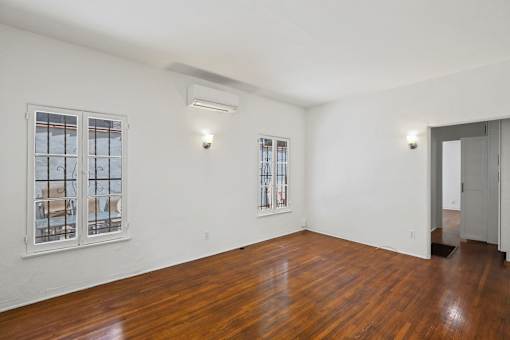 Living Room with Hardwood Floors and In-Suite Air Conditioning Unit