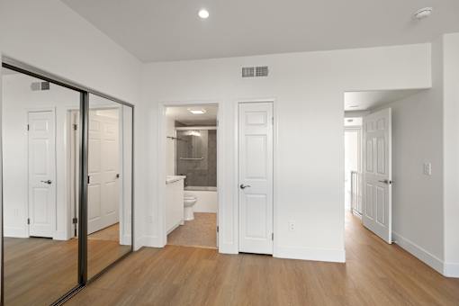 Bedroom with Large-Size Mirrored Closet and Bathroom