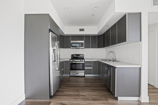 Full-Size Kitchen with Stainless-Steel Refrigerator, Stove, Microwave Oven, and Dishwasher