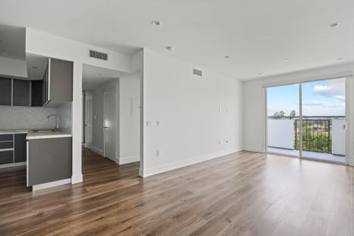 Open-Concept Kitchen, Dining, and Living Room Space with Patio