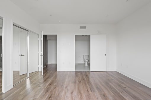 Bedroom with Mirrored Closet, Vinyl Flooring, and Bathroom