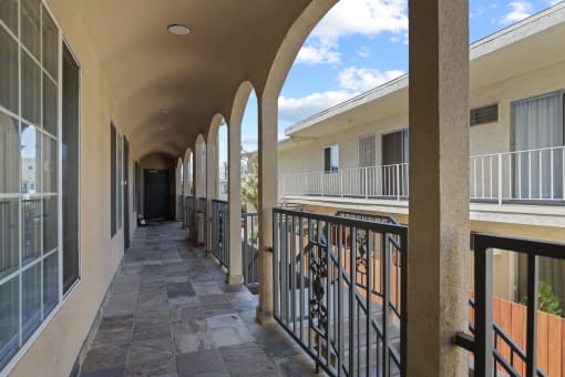 a long corridor with balconies at the whispering winds apartments in pearland, tx