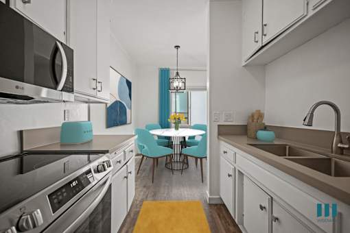 A kitchen with a table and chairs in the middle.
