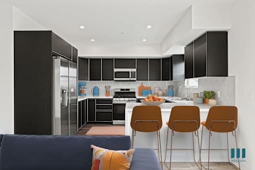 Large-Size Kitchen with Countertop-Bar, Stainless-Steel Appliances, and Ample Cabinet Storage