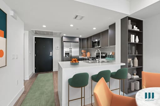 Kitchen with Stainless-Steel Appliances, Countertop bar, and Built-In Shelving