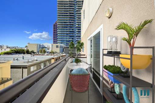 A balcony with a red chair and a plant on it.
