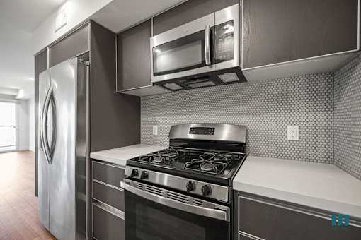 Kitchen with Stainless-Steel Refrigerator, Stove, and Microwave Oven