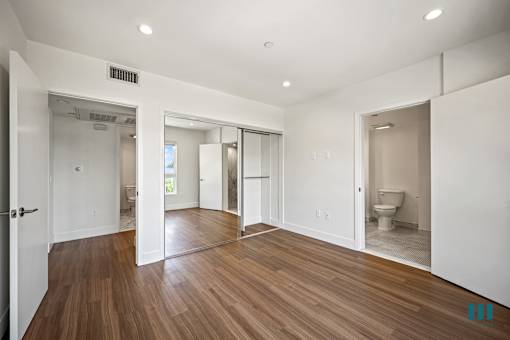 Bedroom with In-Suite Bathroom and Mirrored Closet