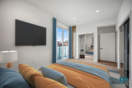 a bedroom with a large bed and a tv