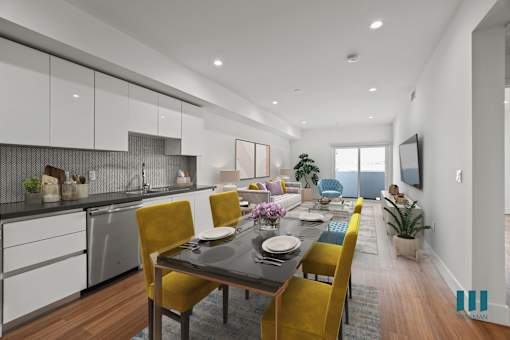 A modern kitchen with a dining table set for four.