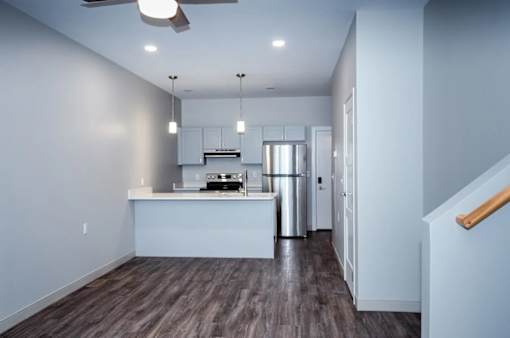 A modern kitchen with a refrigerator, stove, and oven.