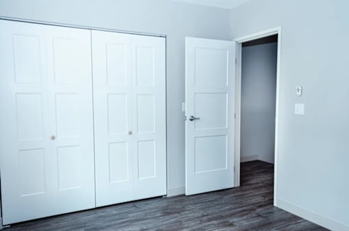 A room with a white door and a white wall.