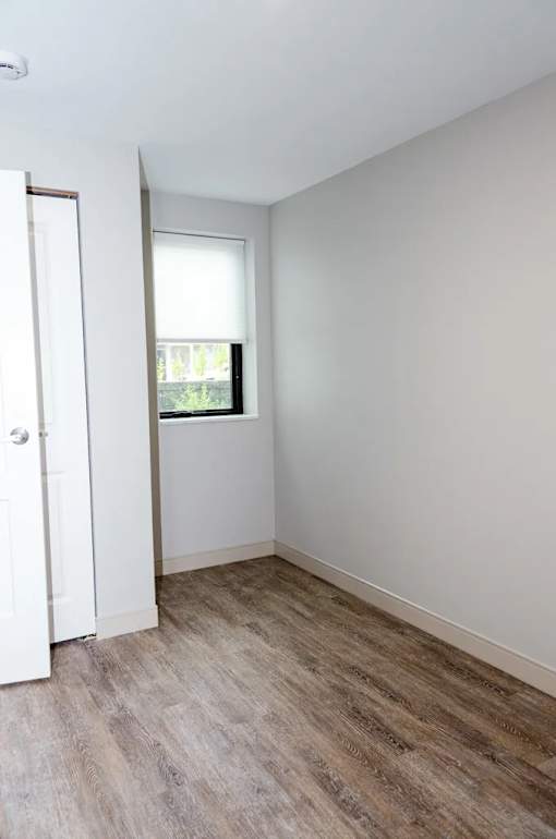 A room with a white door and a window with a white frame.