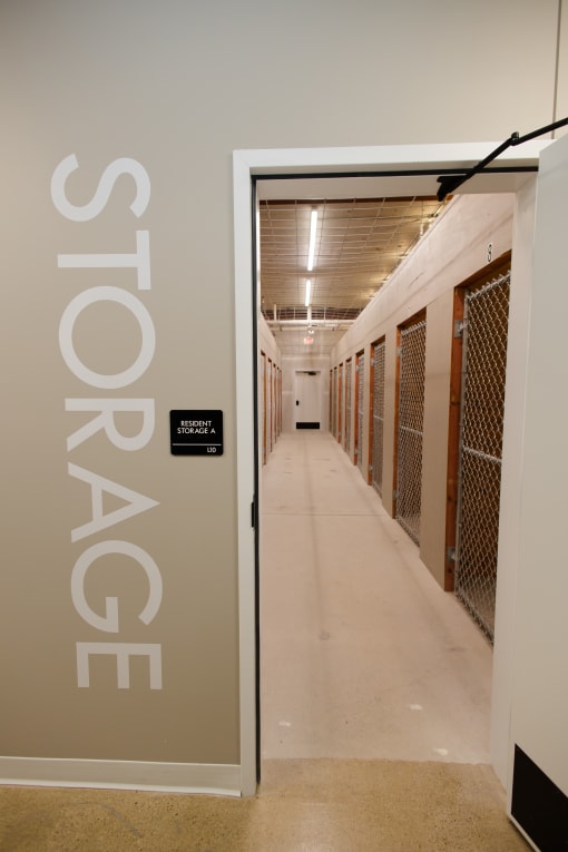 a corridor in a building with a door to a prison cell door
