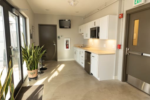 a kitchen with white cabinets and a sink and a refrigerator