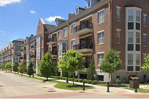 a rendering of an apartment building on a street with trees