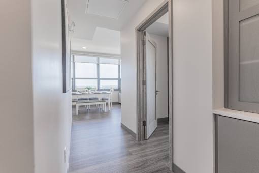 A white room with a table and chairs in the background.