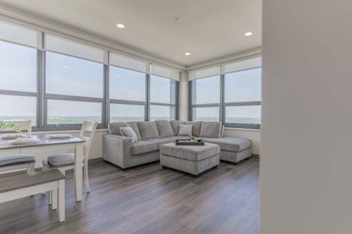 A modern living room with a large window overlooking the ocean.
