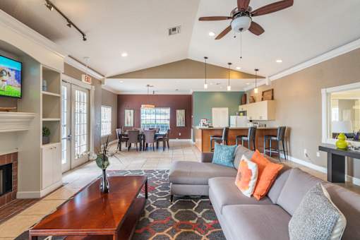 A living room with a grey couch and a wooden coffee table.