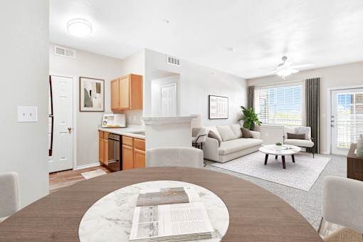 A modern living room with a kitchen area in the background.