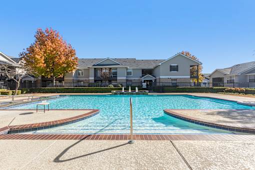 A swimming pool in front of a residential building.