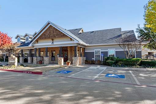 A building with a parking lot in front of it.