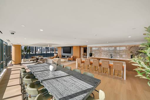 A long table with chairs is in the middle of a room.