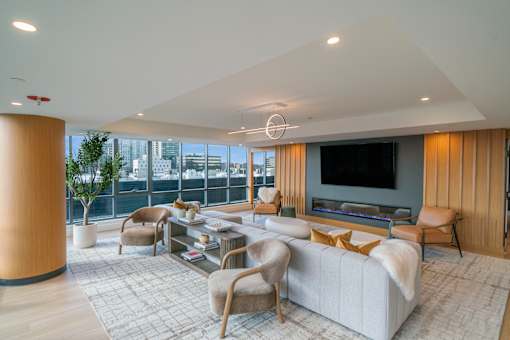 A modern living room with a large couch and a television.