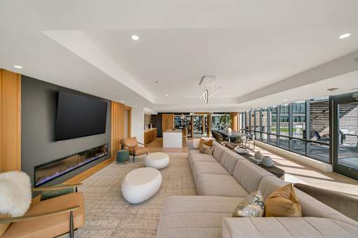A modern living room with a long couch and a flat screen TV.