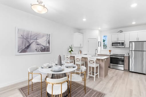 an open kitchen and dining room with a table and chairs