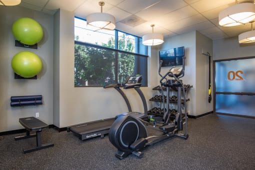a gym with exercise equipment and a window