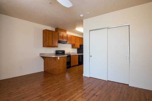 a kitchen and living room with wood flooring and