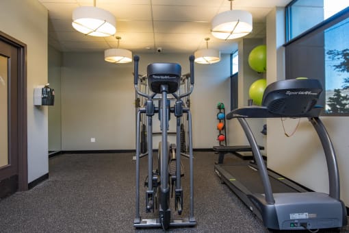 a workout room with weights and a treadmill